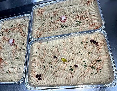 Catering trays of rice, shawarma and salad